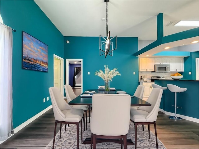 70281 7th St, Covington, LA 70433 - dining area featuring dark wood-style floors, baseboards, and a chandelier