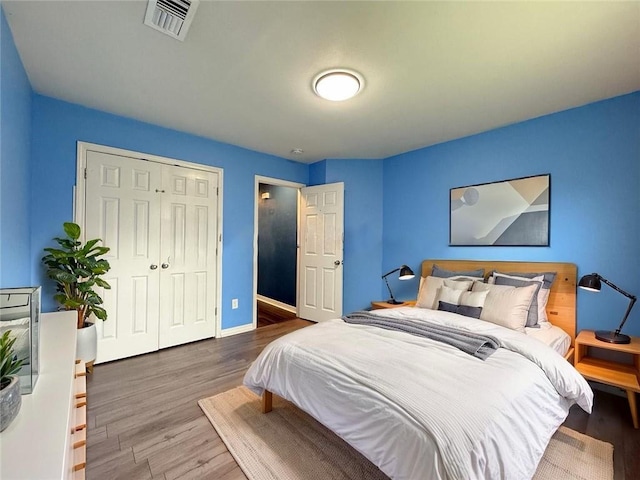 70281 7th St, Covington, LA 70433 - bedroom featuring visible vents, baseboards, a closet, and wood finished floors