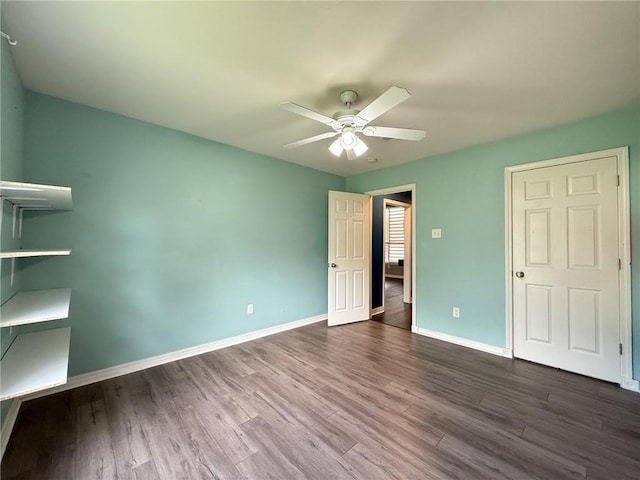 70281 7th St, Covington, LA 70433 - unfurnished bedroom featuring a ceiling fan, dark wood-type flooring, and baseboards