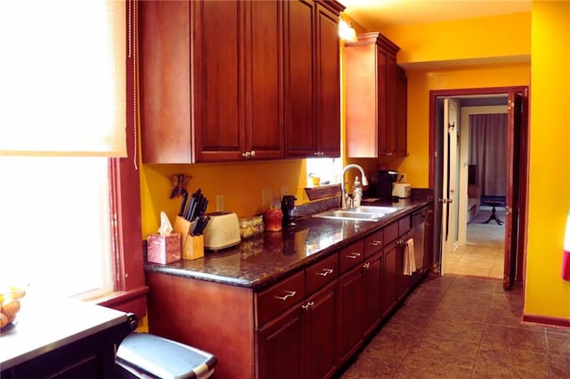 3612 Johnson St, Metairie, LA 70001 - kitchen featuring a sink, healthy amount of natural light, dark tile patterned floors, and dark countertops