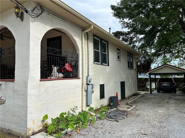 3612 Johnson St, Metairie, LA 70001 - view of side of home with a carport and stucco siding