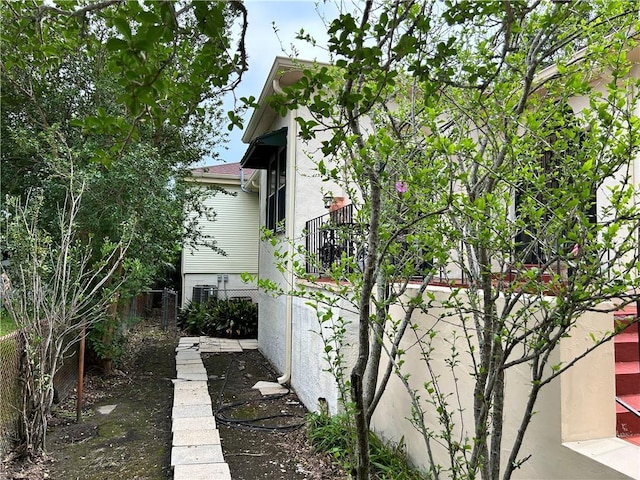 3612 Johnson St, Metairie, LA 70001 - view of side of property featuring stucco siding, fence, and cooling unit
