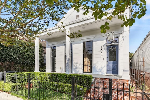 1035 Arabella St, New Orleans, LA 70115 - shotgun-style home with a fenced front yard and covered porch