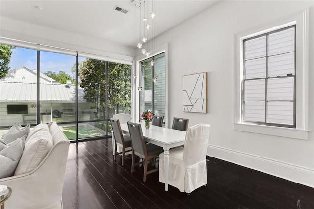 1035 Arabella St, New Orleans, LA 70115 - dining space featuring dark wood-type flooring and baseboards