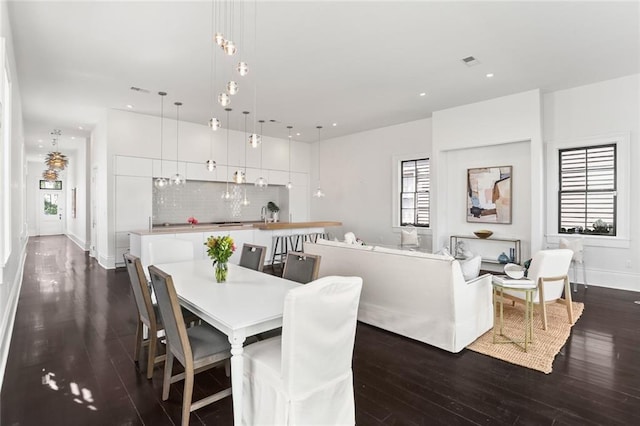 1035 Arabella St, New Orleans, LA 70115 - dining area featuring dark wood-style flooring, recessed lighting, and baseboards
