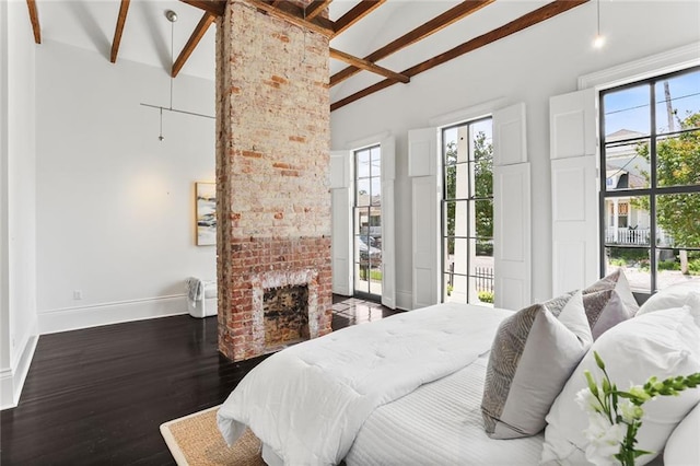 1035 Arabella St, New Orleans, LA 70115 - bedroom with baseboards, wood finished floors, beam ceiling, a brick fireplace, and high vaulted ceiling