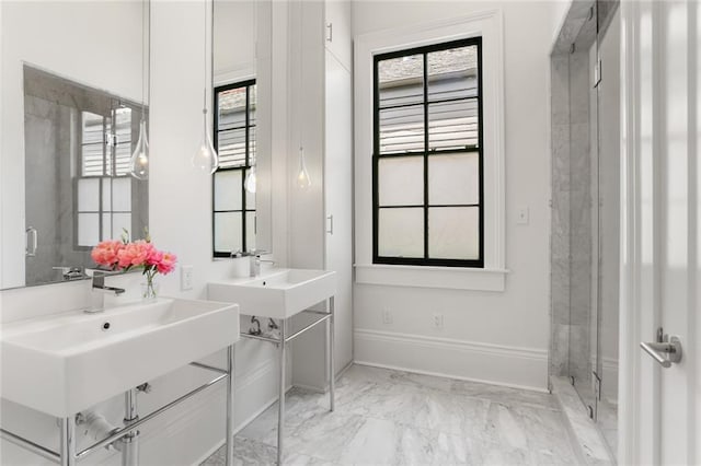 1035 Arabella St, New Orleans, LA 70115 - bathroom featuring marble finish floors, two sinks, and baseboards