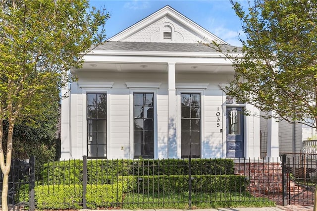 1035 Arabella St, New Orleans, LA 70115 - shotgun-style home featuring a fenced front yard and a shingled roof