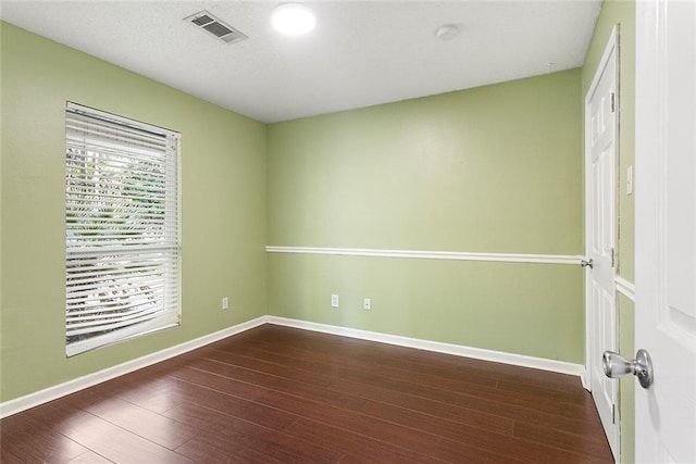 2106 Swan St, Slidell, LA 70460 - spare room featuring plenty of natural light, wood finished floors, and baseboards