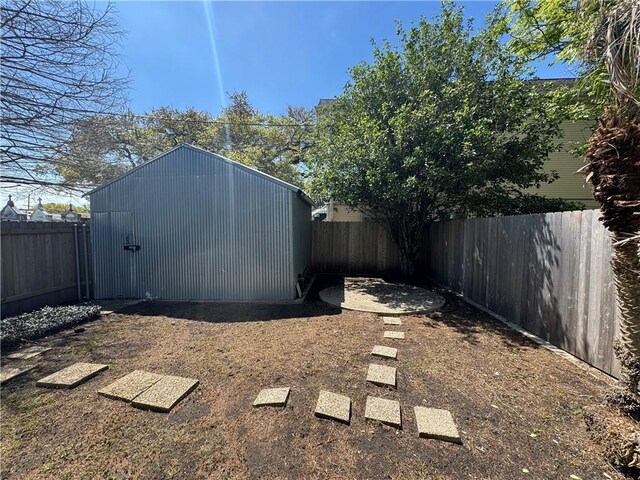 770002 Spruce St, New Orleans, LA 70118 - view of yard featuring an outdoor structure, a fenced backyard, and a storage shed