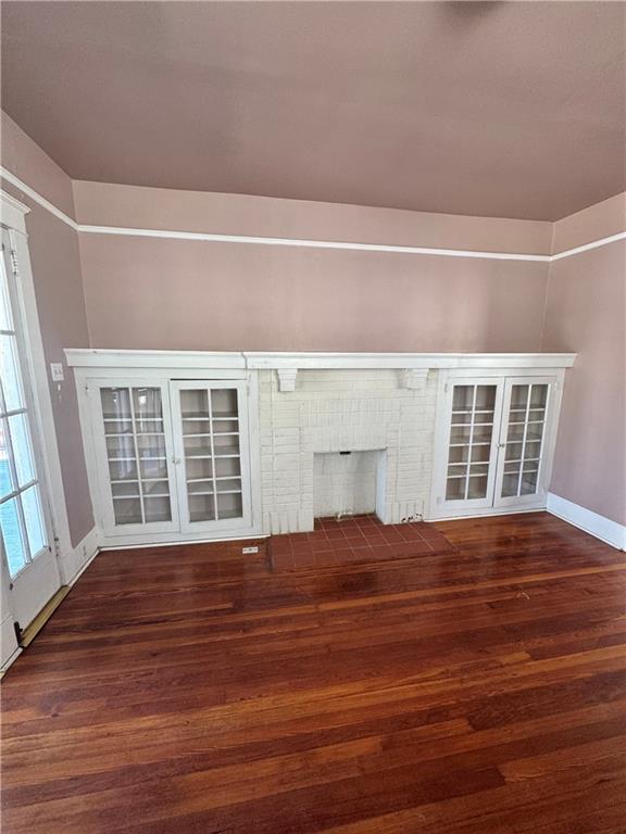 770002 Spruce St, New Orleans, LA 70118 - unfurnished living room with baseboards and wood finished floors