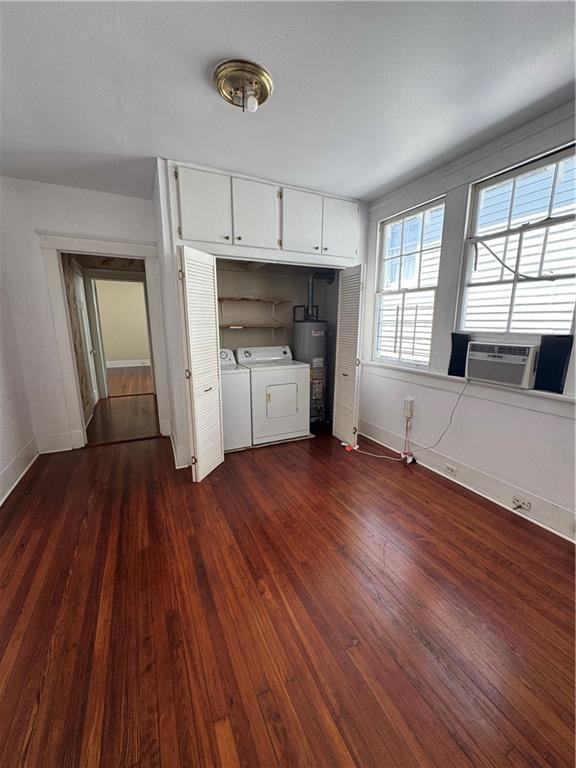 770002 Spruce St, New Orleans, LA 70118 - laundry room with cooling unit, water heater, independent washer and dryer, dark wood-type flooring, and laundry area
