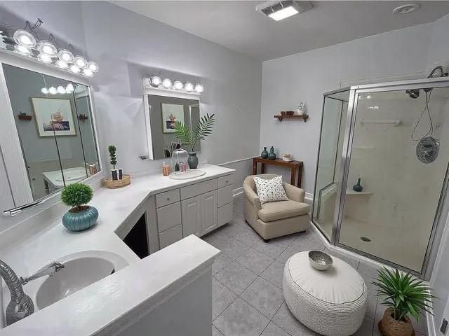 full bathroom featuring a shower stall, vanity, and tile patterned floors