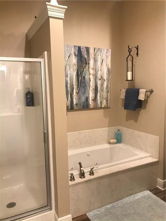 bathroom with a bath and a stall shower
