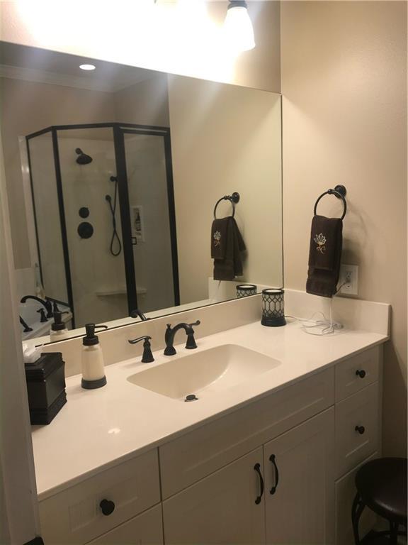 full bath featuring a shower stall and vanity