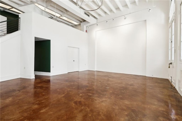 515 Ursulines Ave, New Orleans, LA 70116 - unfurnished room with finished concrete flooring, beamed ceiling, and a high ceiling