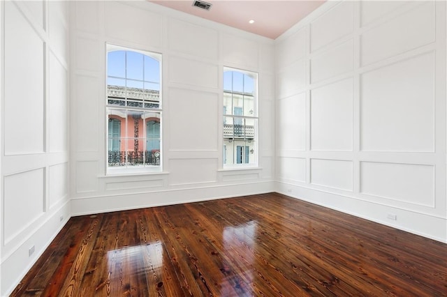 515 Ursulines Ave, New Orleans, LA 70116 - empty room featuring a decorative wall and dark wood-style flooring