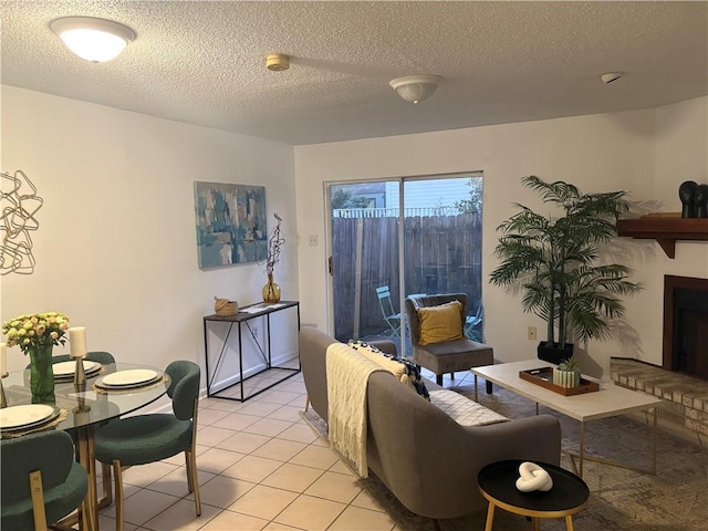 2626 Lepage St, New Orleans, LA 70119 - living room with light tile patterned floors, a textured ceiling, and a fireplace