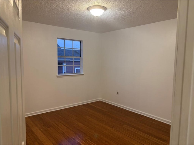2626 Lepage St, New Orleans, LA 70119 - empty room featuring dark wood-style floors and a textured ceiling