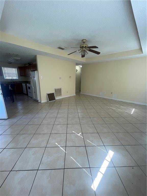 4941 Viola St, New Orleans, LA 70126 - unfurnished living room with light tile patterned floors, ceiling fan, a raised ceiling, and a textured ceiling