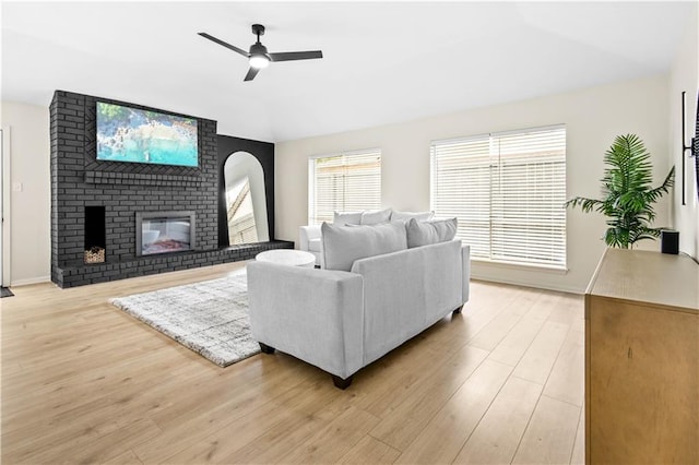 146 Bluefield Dr, Slidell, LA 70458 - living room with vaulted ceiling, ceiling fan, light wood-style flooring, a brick fireplace, and baseboards