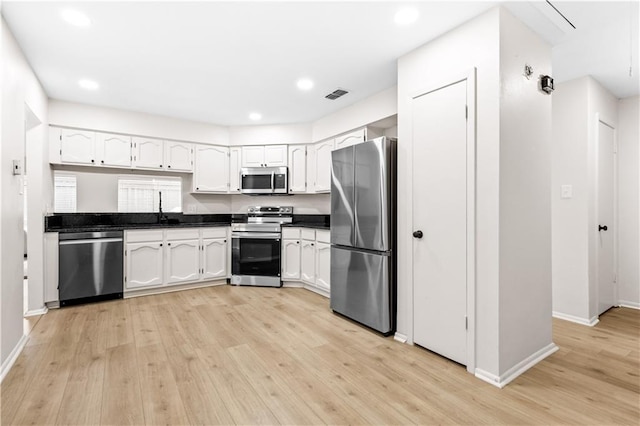 146 Bluefield Dr, Slidell, LA 70458 - kitchen featuring stainless steel appliances, dark countertops, baseboards, light wood finished floors, and recessed lighting