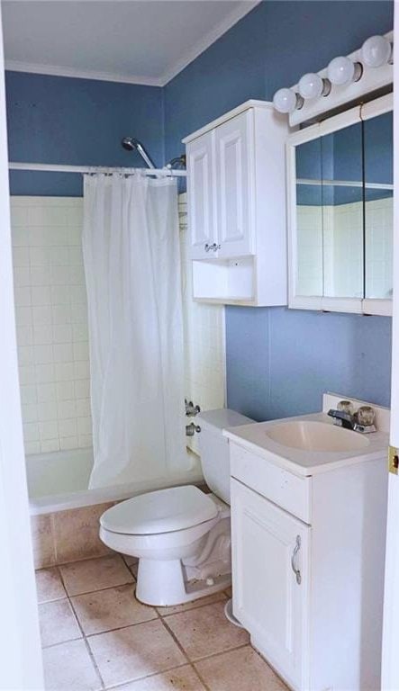 full bathroom with tile patterned floors, toilet, shower / tub combo with curtain, and vanity