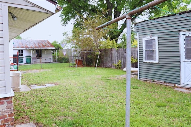 view of yard featuring a fenced backyard and an outbuilding