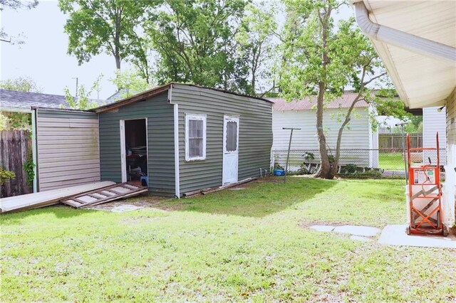 exterior space with an outbuilding and fence private yard