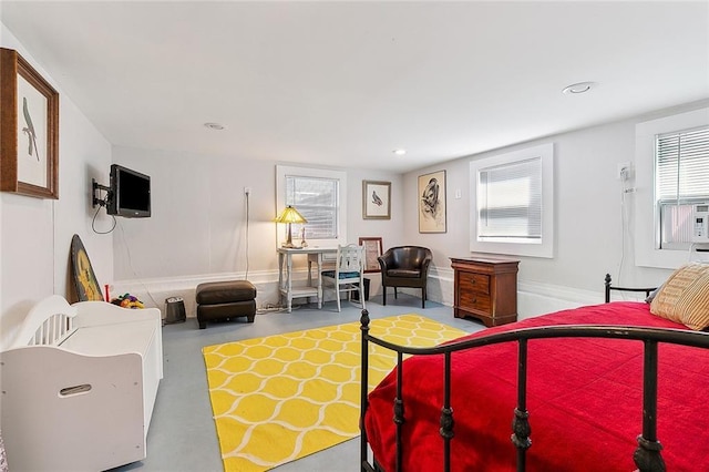 bedroom featuring baseboards, recessed lighting, and finished concrete floors