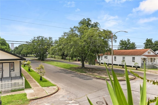 view of street with curbs, street lighting, and sidewalks