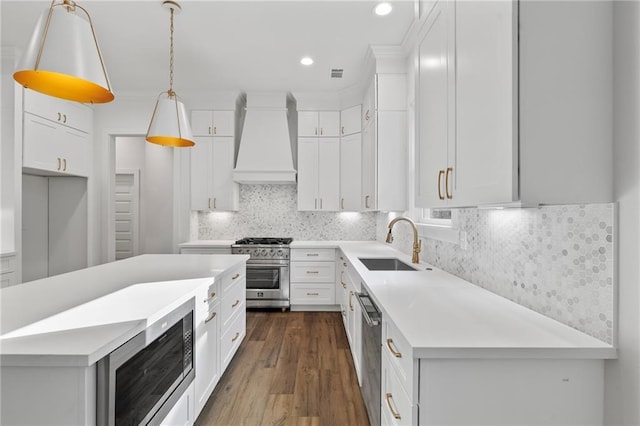 507 W 7th Ave, Covington, LA 70433 - kitchen with appliances with stainless steel finishes, custom exhaust hood, a sink, white cabinets, and dark wood finished floors
