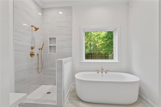 507 W 7th Ave, Covington, LA 70433 - bathroom featuring tiled shower, baseboards, and a soaking tub