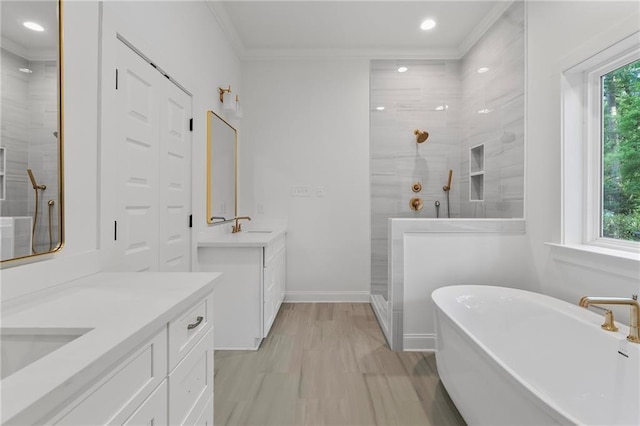 507 W 7th Ave, Covington, LA 70433 - full bath with a shower stall, two vanities, crown molding, baseboards, and a freestanding bath
