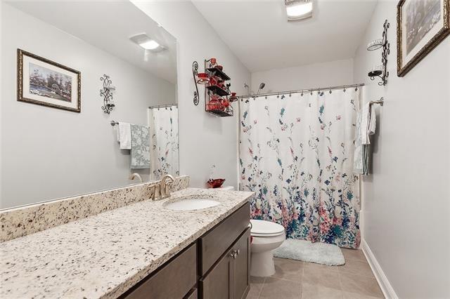 9554 W Keri Ln, Waggaman, LA 70094 - bathroom with vanity, toilet, tile patterned flooring, and a shower with shower curtain