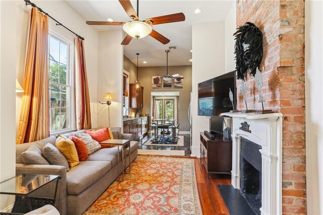 2224 N Rampart St, New Orleans, LA 70116 - living area with ceiling fan, healthy amount of natural light, a fireplace, dark wood finished floors, and recessed lighting