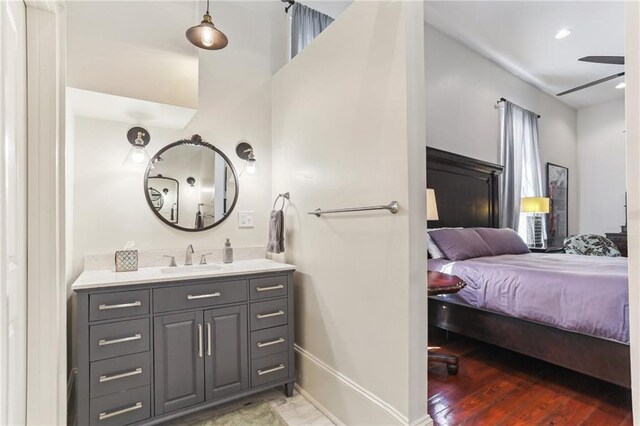 2224 N Rampart St, New Orleans, LA 70116 - ensuite bathroom featuring vanity, ceiling fan, and wood finished floors
