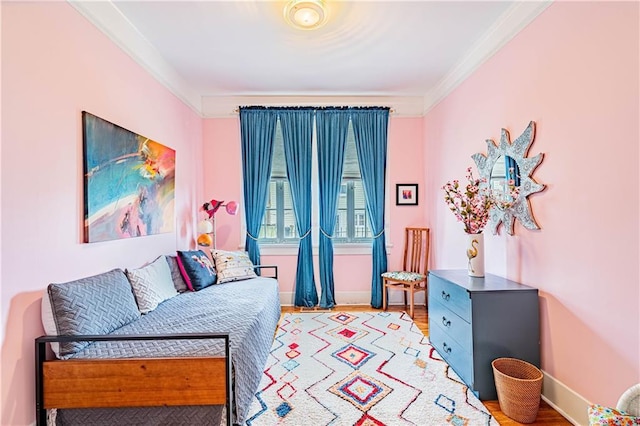 interior space featuring light wood-style flooring, crown molding, and baseboards