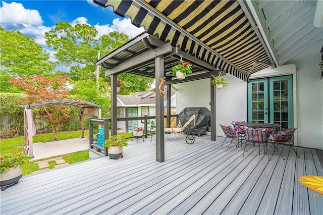 wooden terrace featuring a pergola, grilling area, and fence