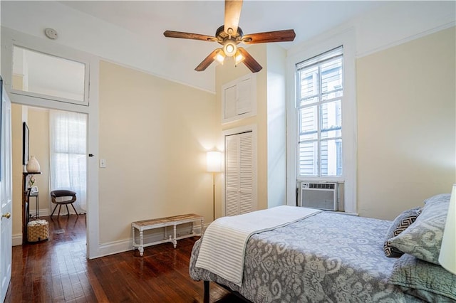 bedroom with a closet, baseboards, a ceiling fan, cooling unit, and wood-type flooring