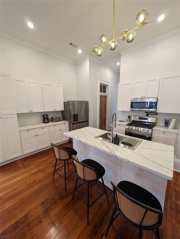 kitchen featuring a sink, visible vents, white cabinets, and appliances with stainless steel finishes