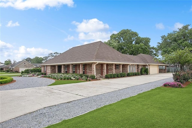 102 Liberty St, Belle Chasse, LA 70037 - view of front of home with concrete driveway, brick siding, an attached garage, and a front lawn