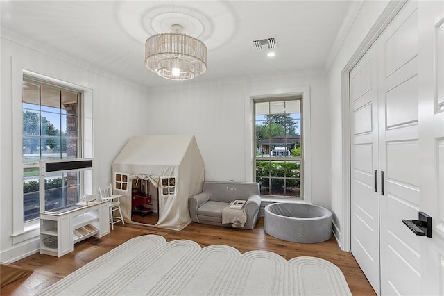 102 Liberty St, Belle Chasse, LA 70037 - bedroom featuring a notable chandelier, visible vents, ornamental molding, and wood finished floors