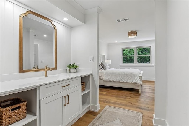 102 Liberty St, Belle Chasse, LA 70037 - ensuite bathroom featuring vanity, recessed lighting, ensuite bath, visible vents, and wood finished floors