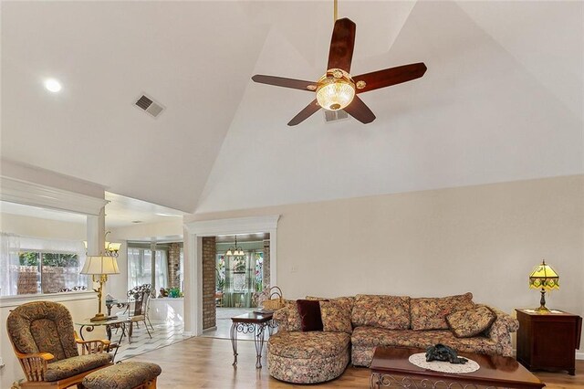 3605 W Grandlake Blvd, Kenner, LA 70065 - living room featuring high vaulted ceiling, visible vents, ceiling fan with notable chandelier, and light wood-style flooring