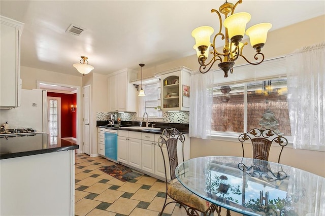 3605 W Grandlake Blvd, Kenner, LA 70065 - kitchen featuring visible vents, a sink, dark countertops, dishwashing machine, and backsplash