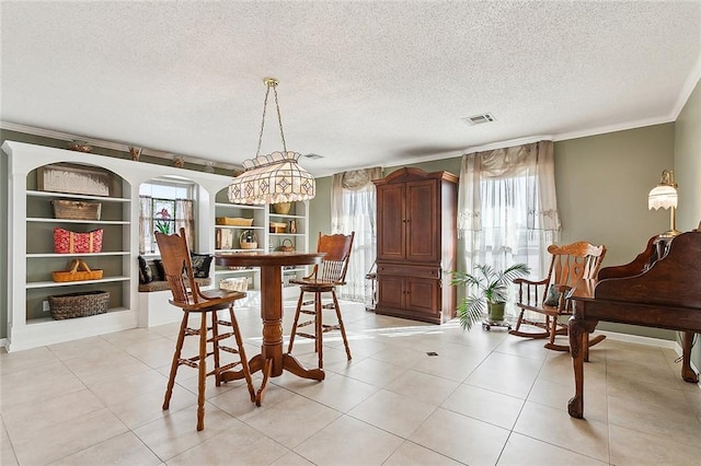 3605 W Grandlake Blvd, Kenner, LA 70065 - dining space featuring crown molding, visible vents, light tile patterned floors, and a textured ceiling