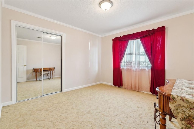 3605 W Grandlake Blvd, Kenner, LA 70065 - carpeted bedroom featuring crown molding, a closet, baseboards, and a textured ceiling