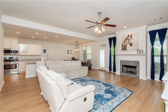 201 Belle Pointe Dr, Madisonville, LA 70447 - living room with healthy amount of natural light, crown molding, ceiling fan, recessed lighting, and light wood-type flooring