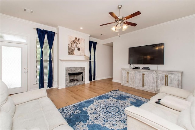 201 Belle Pointe Dr, Madisonville, LA 70447 - living area with ceiling fan, wood finished floors, ornamental molding, baseboards, and a fireplace